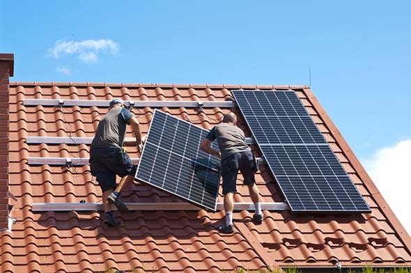 installing new solar panels on the roof of a private house
